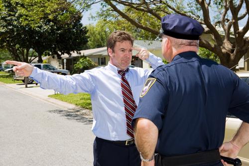 A police officer giving a driver a field sobriety test